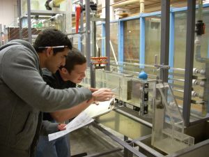 Students inspect fluid mechanics equipment