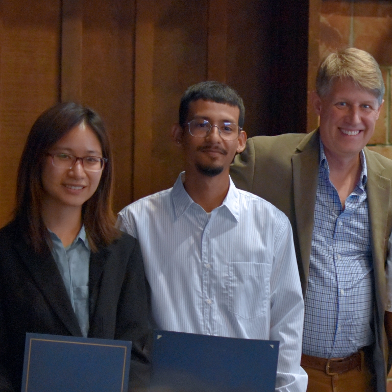 Chair Stacey presents the Charles G. Hyde Memorial Fund Fellowship to Phoebe Chen and Roberto Andrade-Moreno (left to right). (Photo Credit: Erin Leigh Inama).