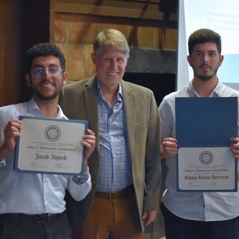 Chair Stacey presents the John C. Shimmick Scholarship to Jacob Ahmed and Edwin Reyes Barreras (left to right). (Photo Credit: Erin Leigh Inama).