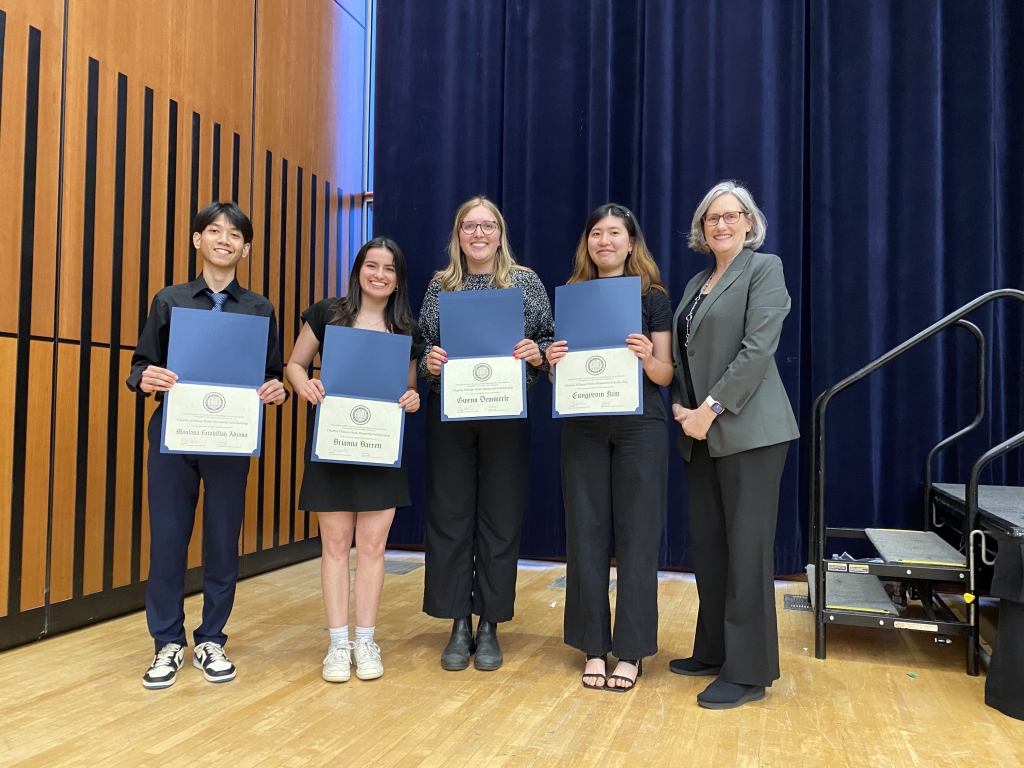 Chair Joan Walker presents the Charles G. Hyde Memorial Fund Fellowship to Maulana Fatahillah Adzima, Brianna Marie Barrett, Gwenn Demmerle, and Eungyeom Kim. (Pictured left to right: Maulana Fatahillah Adzima, Brianna Marie Barrett, Gwenn Demmerle, Eungyeom Kim, and Chair Joan Walker. Photo Credit: Sarah Shaadi Sadeh)