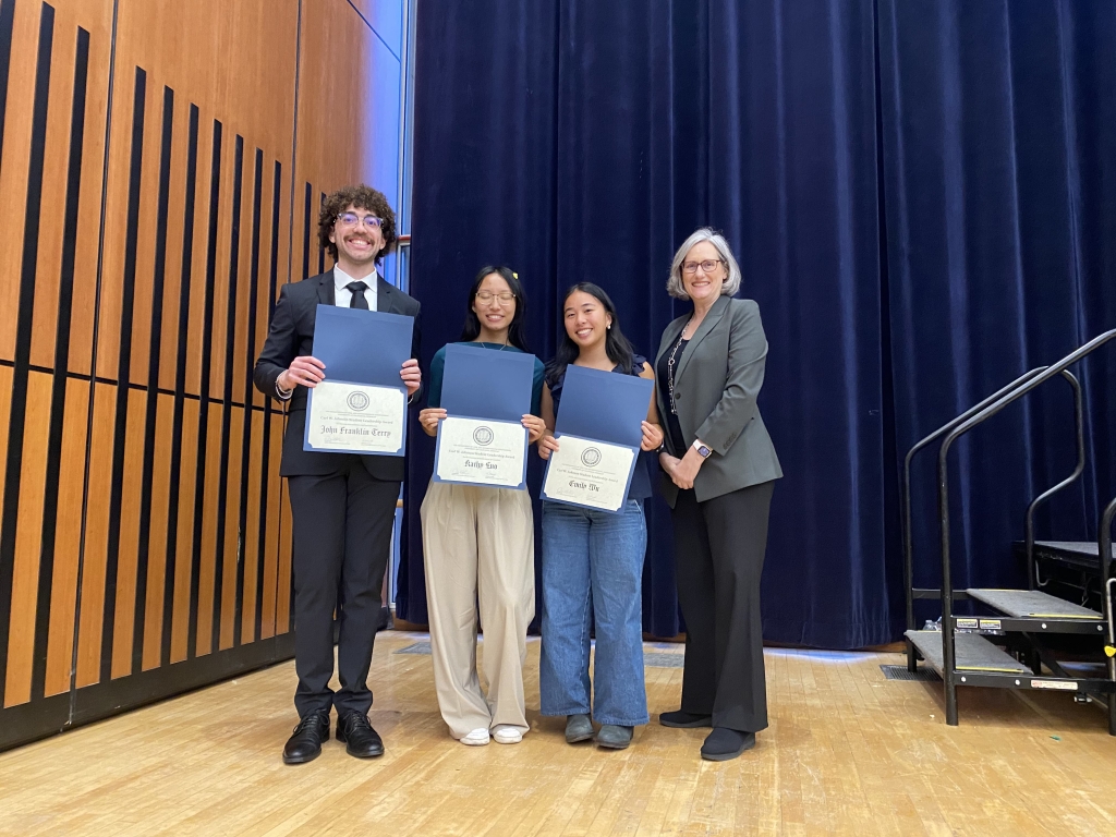 Chair Joan Walker presents the Carl W. Johnson Leadership Award to John Franklin Terry, Kathy Luo, and Emily Wu. (Pictured left to right: John Franklin Terry, Kathy Luo, Emily Wu, and Chair Joan Walker. Photo Credit: Sarah Shaadi Sadeh)