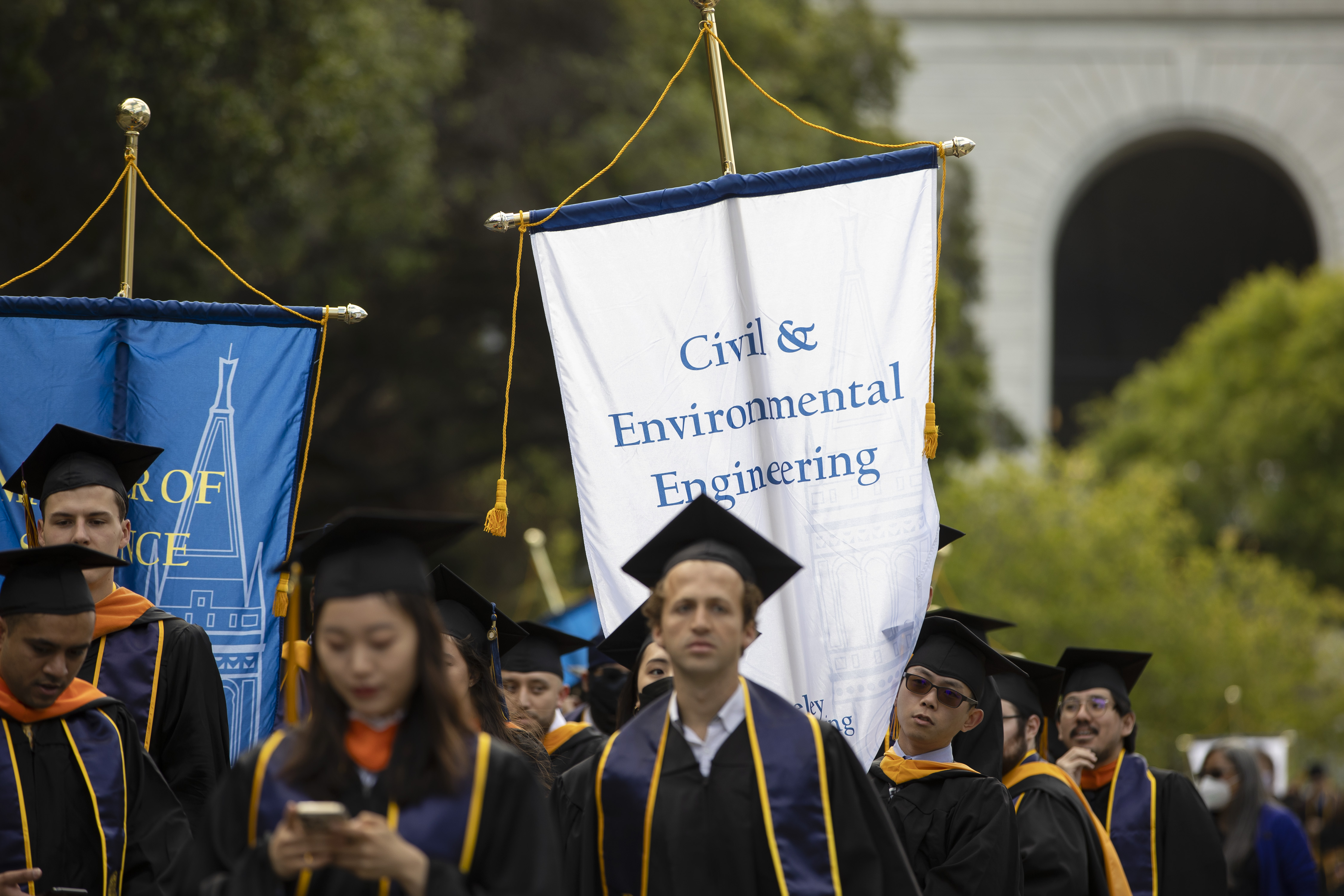 Undergraduate students holding the Civil & Environmental Engineering banner during baccalaureate commencement ceremony (Photo Credit: Brittany Hosea)