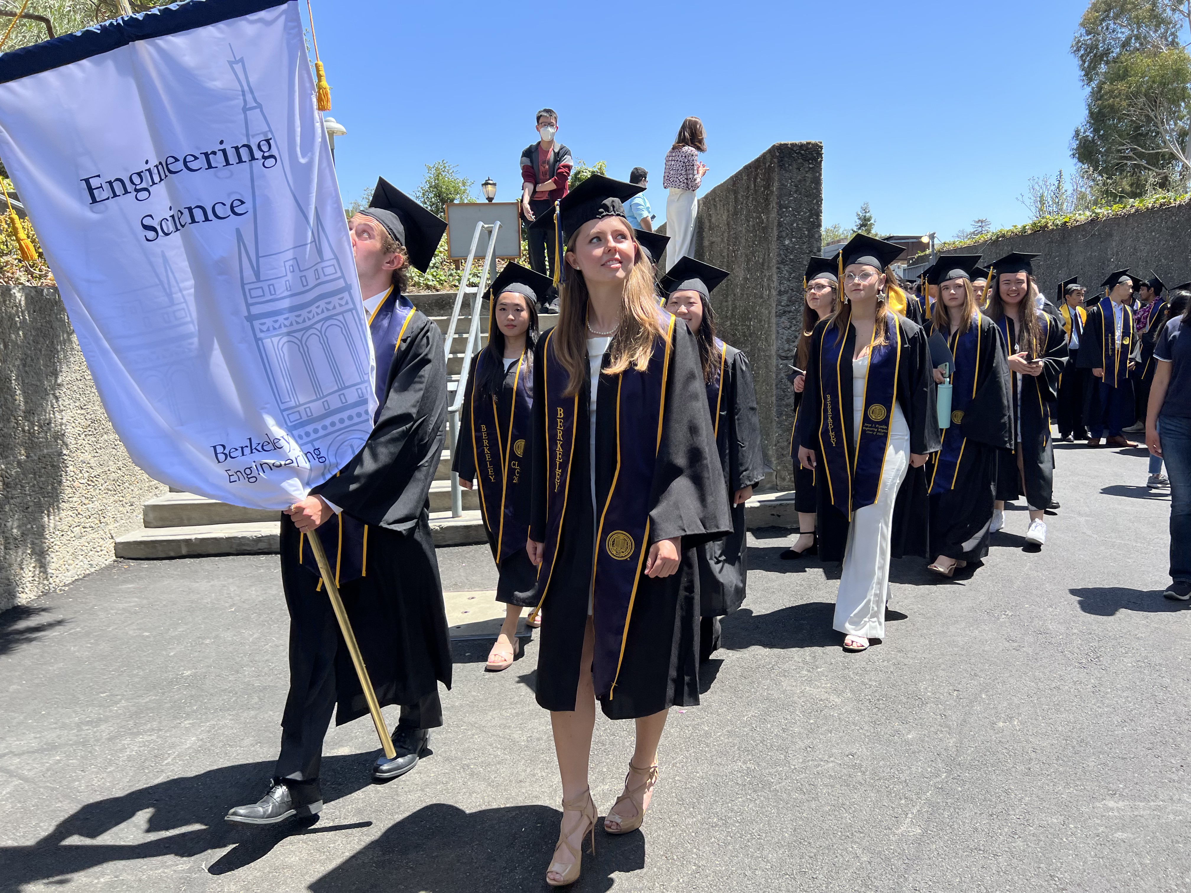 Engineering Science students walking with Engineering Science banner Engineering Science banner during the baccalaureate commencement ceremony (Photo Credit: Jessica Zhang)