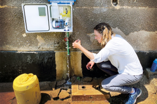 Professor Amy Pickering is testing the residue of chlorine added to the water filtration device created by her and her team in a hospital in Busia, Kenya (Photo Credit: Katya Cherukumilli for Nature)