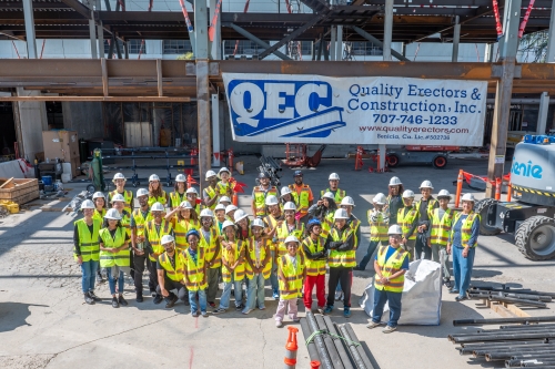 A group photo of the NWA Summer Camp in front of the construction site for the new Bechtel Engineering Center. (Photo Credit: Rhett Jones)