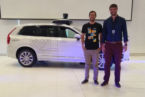 Juan Argote and intern in front of Uber car
