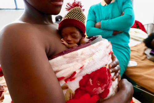 A newborn infant receives supplemental warming with the Infant Warmer. Image courtesy of Global Newborn Solutions™