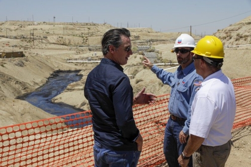 Gov. Gavin Newsom at an oil creek bed.