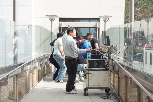 Students from CE 249 are jumping simultaneously to evaluate the bridge's condition and get frequency data points using a computer.