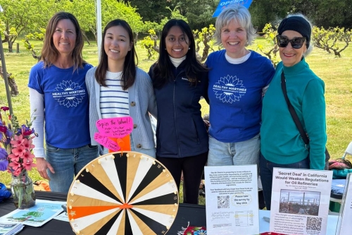 A group photo of the Berkeley CEE table at the 2025 John Muir Birthday and Earth Day Celebration with the non-profit group, Healthy Martinez including CEE Ph.D. students Sumukhi Prasad and Yi Ji. (Photo Credit: Sumukhi Prasad)