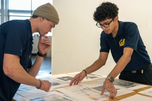 Carlos Quezada works on a tight deadline with a fellow team member at a construction competition involving students from some 20 schools in the western U.S. Quezada was inspired to a career in engineering by his experience in a major earthquake. (Photo/Caption Credit: Nicholas Pham/UC Berkeley News)